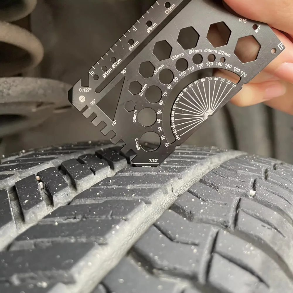Credit Card Multitool 1 being used to check tyre tread depth
