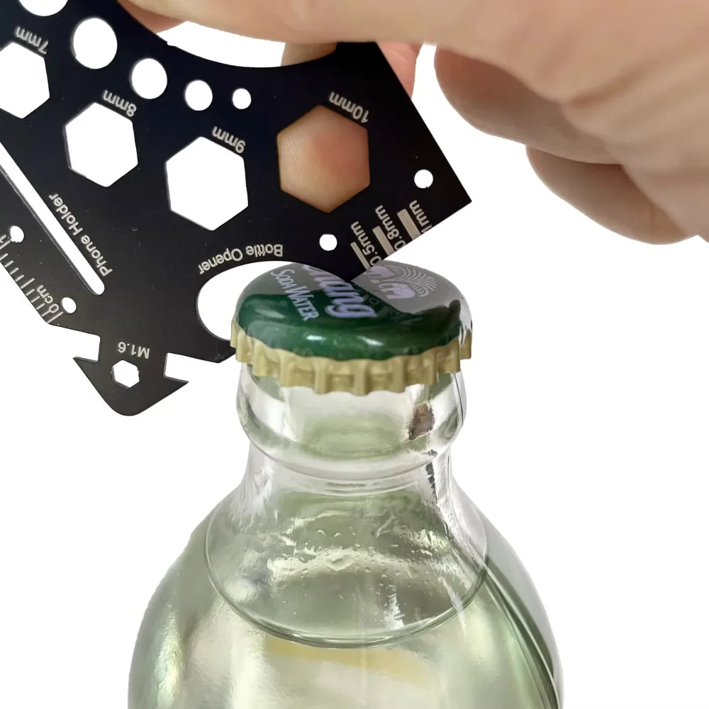 Credit Card Multitool 1 used to open a bottle with the built-in bottle opener
