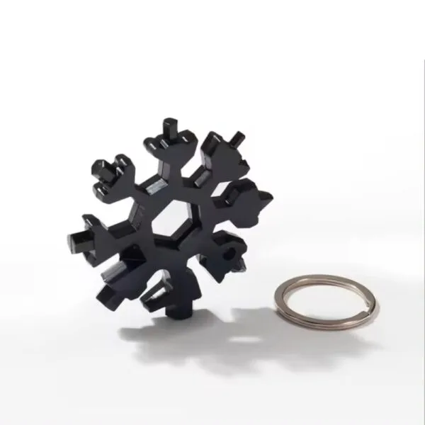 Black Snowflake Multitool Keychain standing next to a keyring