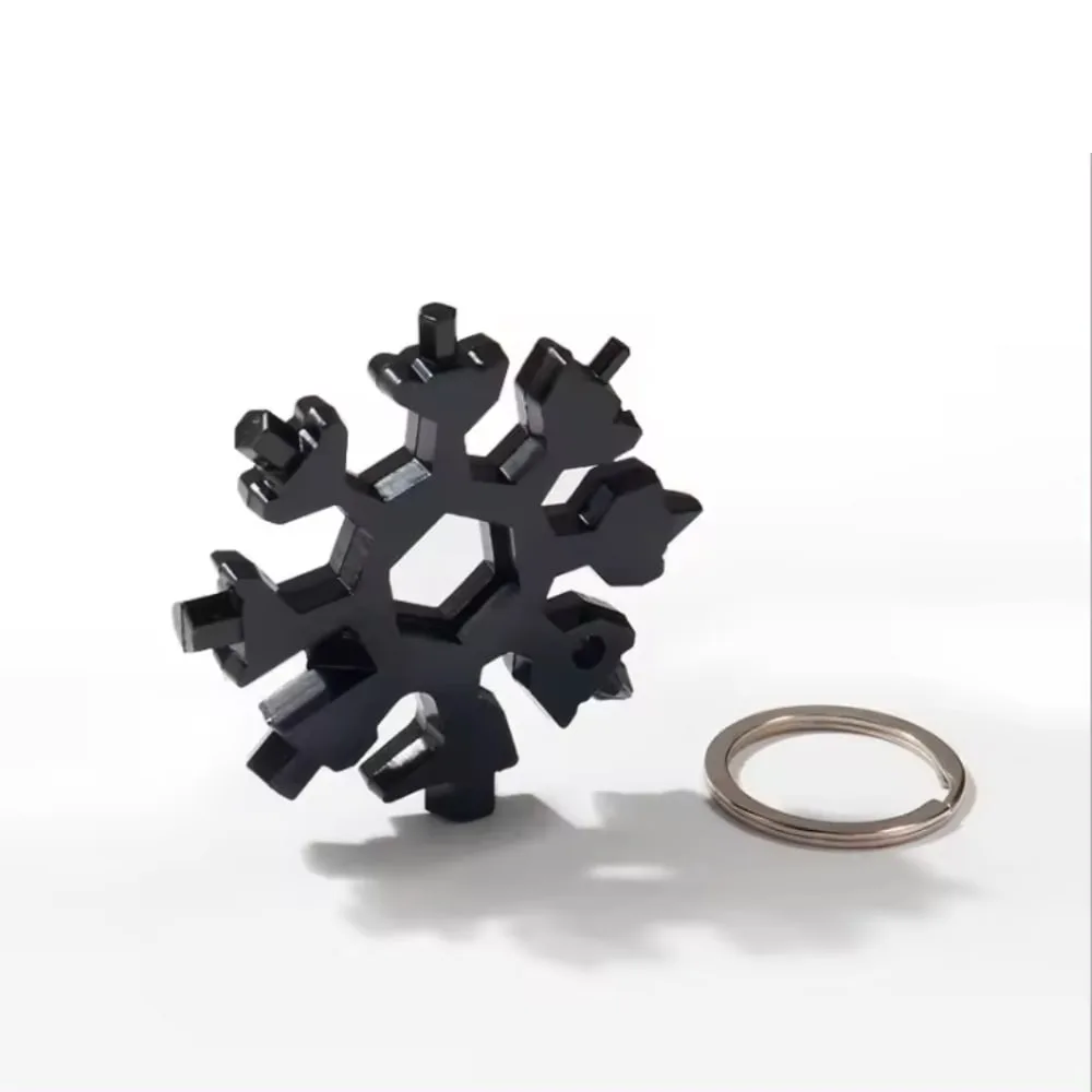 Black Snowflake Multitool Keychain standing next to a keyring